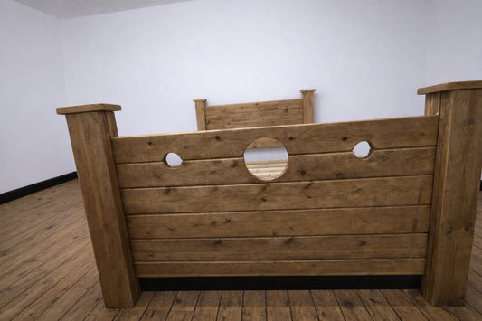 The Jester Bed wooden stocks footboard with modesty planks
