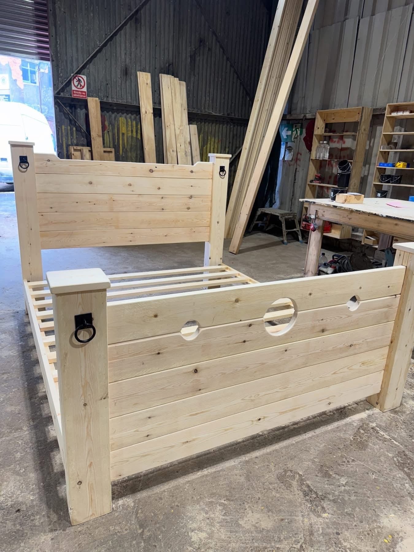 The Jester Bed wooden stocks and headboard workshop view